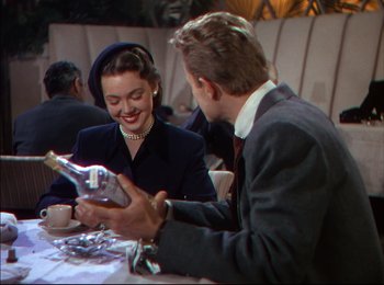 Movie still from “When Worlds Collide” (1951), directed by Rudolph Maté – A man and a woman sitting at a table; Medium shot, High angle