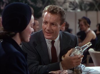 Movie still from “When Worlds Collide” (1951), directed by Rudolph Maté – A man and a woman sitting at a table; Medium shot, Over the shoulder angle