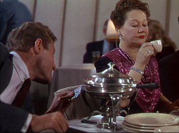 Movie still from “When Worlds Collide” (1951), directed by Rudolph Maté – An older woman and a young man sitting at a table; Medium shot, Over the shoulder angle