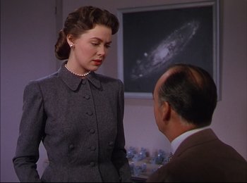 Movie still from “When Worlds Collide” (1951), directed by Rudolph Maté – A woman in a gray dress and a man in a suit; Medium shot, Over the shoulder angle