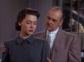 Movie still from “When Worlds Collide” (1951), directed by Rudolph Maté – An older man in a suit and tie next to an older woman in a dress; Medium shot, Over the shoulder angle