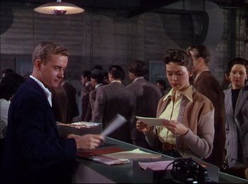 Movie still from “When Worlds Collide” (1951), directed by Rudolph Maté – A man and a woman looking at a piece of paper; Medium shot, Low angle