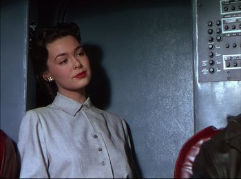 Movie still from “When Worlds Collide” (1951), directed by Rudolph Maté – A woman standing in front of an elevator; Medium shot, Low angle