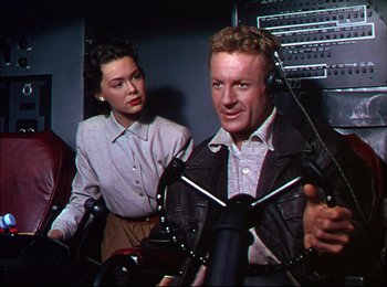 Movie still from “When Worlds Collide” (1951), directed by Rudolph Maté – A man and a woman are standing next to each other; Medium shot, High angle