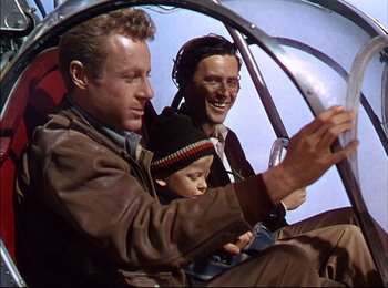 Movie still from “When Worlds Collide” (1951), directed by Rudolph Maté – Two men and a child are sitting in a helicopter cockpit; Medium shot, Overhead angle