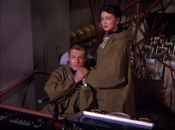 Movie still from “When Worlds Collide” (1951), directed by Rudolph Maté – A man and a woman are standing in front of a machine; Medium shot, Low angle