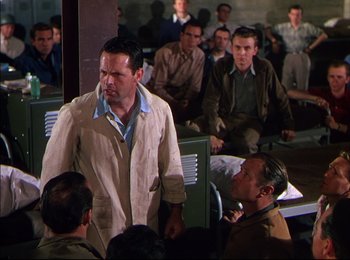 Movie still from “When Worlds Collide” (1951), directed by Rudolph Maté – A group of men sitting in a room; Medium shot, Over the shoulder angle