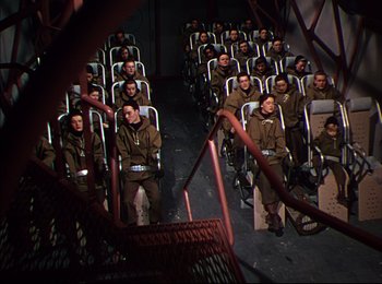 Movie still from “When Worlds Collide” (1951), directed by Rudolph Maté – A group of people sitting in seats in a room; Wide shot, High angle