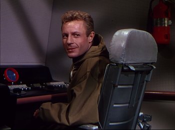 Movie still from “When Worlds Collide” (1951), directed by Rudolph Maté – A man sitting in a chair in an airplane; Medium shot, Low angle