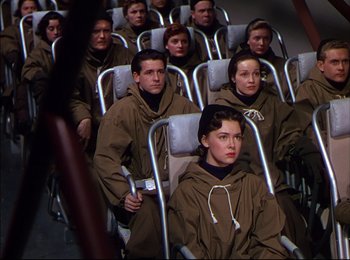Movie still from “When Worlds Collide” (1951), directed by Rudolph Maté – A group of people sitting in a row of chairs; Medium shot, High angle