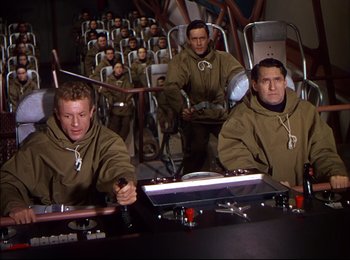 Movie still from “When Worlds Collide” (1951), directed by Rudolph Maté – A group of men sitting at a table in a room; Wide shot, High angle
