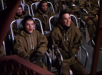 Movie still from “When Worlds Collide” (1951), directed by Rudolph Maté – A group of people sitting in a row of chairs; Medium shot, High angle