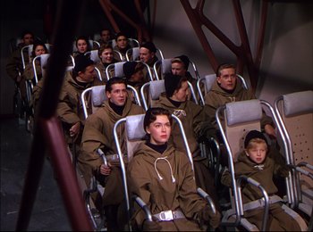Movie still from “When Worlds Collide” (1951), directed by Rudolph Maté – A group of people sitting in chairs in a room; Wide shot, High angle