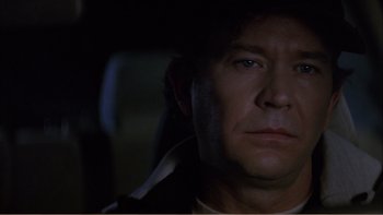 Movie still from “When a Man Falls” (2007), directed by Ryan Eslinger – A person in a car at night; Close Up shot, Low angle