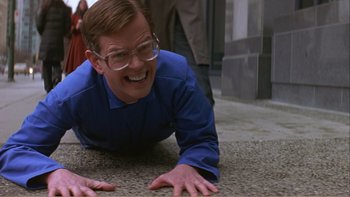 Movie still from “When a Man Falls” (2007), directed by Ryan Eslinger – A man laying on the ground with his hands on the ground; Medium shot, High angle