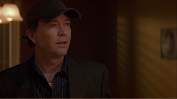 Movie still from “When a Man Falls” (2007), directed by Ryan Eslinger – A person wearing a hat; Close Up shot, Over the shoulder angle