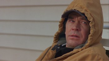 Movie still from “When a Man Falls” (2007), directed by Ryan Eslinger – A person wearing a hooded jacket; Close Up shot, Low angle
