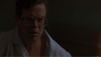 Movie still from “When a Man Falls” (2007), directed by Ryan Eslinger – A man wearing glasses and a white shirt; Close Up shot, Over the shoulder angle