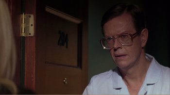 Movie still from “When a Man Falls” (2007), directed by Ryan Eslinger – An older woman wearing glasses looking at the camera; Close Up shot, Over the shoulder angle