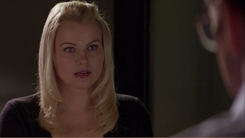 Movie still from “When a Man Falls” (2007), directed by Ryan Eslinger – A woman with blonde hair and a black shirt; Close Up shot, Over the shoulder angle