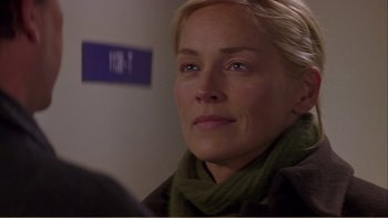 Movie still from “When a Man Falls” (2007), directed by Ryan Eslinger – A person wearing a green scarf; Close Up shot, Over the shoulder angle