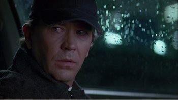 Movie still from “When a Man Falls” (2007), directed by Ryan Eslinger – A person wearing a hat; Close Up shot, Over the shoulder angle