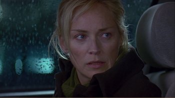 Movie still from “When a Man Falls” (2007), directed by Ryan Eslinger – A person in a car looking at the camera; Close Up shot, Over the shoulder angle