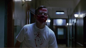 Movie still from “When a Man Falls” (2007), directed by Ryan Eslinger – A man with blood all over his face; Close Up shot, Low angle