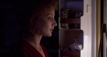 Movie still from “When a Stranger Calls” (1979), directed by Fred Walton – A woman looking into a refrigerator at night time; Close Up shot, Low angle