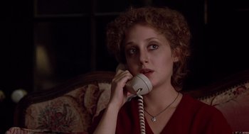 Movie still from “When a Stranger Calls” (1979), directed by Fred Walton – A woman sitting in a chair talking on a phone; Close Up shot, High angle