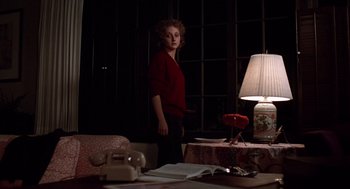 Movie still from “When a Stranger Calls” (1979), directed by Fred Walton – A woman standing in front of a table with a lamp; Medium shot, Low angle