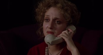 Movie still from “When a Stranger Calls” (1979), directed by Fred Walton – A woman holding a phone up to her ear; Close Up shot, High angle