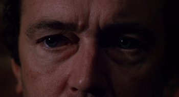 Movie still from “When a Stranger Calls” (1979), directed by Fred Walton – A man's eyes in the dark; Extreme Close Up shot, Overhead angle