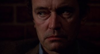 Movie still from “When a Stranger Calls” (1979), directed by Fred Walton – A man's face in the dark; Close Up shot, Over the shoulder angle