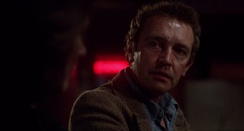 Movie still from “When a Stranger Calls” (1979), directed by Fred Walton – A person wearing a jacket; Close Up shot, Over the shoulder angle