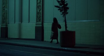 Movie still from “When a Stranger Calls” (1979), directed by Fred Walton – A woman walking down the street at night; Wide shot, Low angle