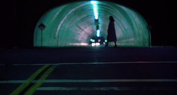 Movie still from “When a Stranger Calls” (1979), directed by Fred Walton – A woman walking down a street at night; Extreme Wide shot, Low angle
