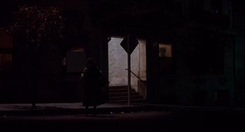 Movie still from “When a Stranger Calls” (1979), directed by Fred Walton – A woman walking down a street at night; Wide shot, High angle