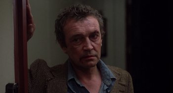 Movie still from “When a Stranger Calls” (1979), directed by Fred Walton – A person wearing a jacket; Close Up shot, Over the shoulder angle