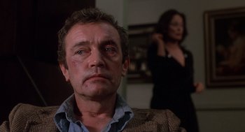 Movie still from “When a Stranger Calls” (1979), directed by Fred Walton – A person wearing a suit and tie; Close Up shot, Over the shoulder angle