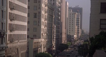Movie still from “When a Stranger Calls” (1979), directed by Fred Walton – A view of a street with many tall buildings on both sides of the street; Extreme Wide shot, High angle