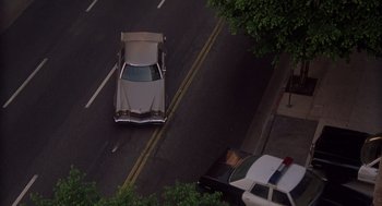 Movie still from “When a Stranger Calls” (1979), directed by Fred Walton – An aerial view of a police car on the street; Extreme Wide shot, High angle