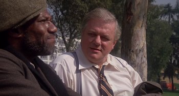 Movie still from “When a Stranger Calls” (1979), directed by Fred Walton – A man in a white dress shirt and a man in a black tie; Close Up shot, Over the shoulder angle