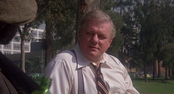 Movie still from “When a Stranger Calls” (1979), directed by Fred Walton – An older man wearing a white dress shirt and a tie; Close Up shot, Over the shoulder angle