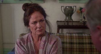 Movie still from “When a Stranger Calls” (1979), directed by Fred Walton – A person sitting on a couch; Close Up shot, Over the shoulder angle