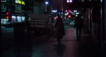 Movie still from “When a Stranger Calls” (1979), directed by Fred Walton – Two people walking down a sidewalk at night; Wide shot, Low angle