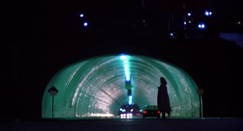 Movie still from “When a Stranger Calls” (1979), directed by Fred Walton – A woman is standing in front of a tunnel; Wide shot, Low angle