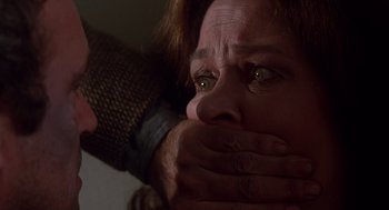 Movie still from “When a Stranger Calls” (1979), directed by Fred Walton – A woman with her hands over her mouth; Close Up shot, Over the shoulder angle