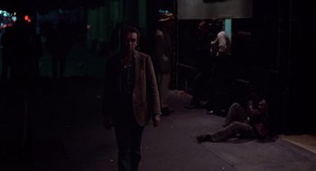 Movie still from “When a Stranger Calls” (1979), directed by Fred Walton – A man walking down a street at night; Wide shot, High angle