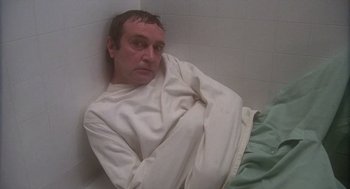 Movie still from “When a Stranger Calls” (1979), directed by Fred Walton – A man sitting in the corner of a bathtub; Medium shot, High angle